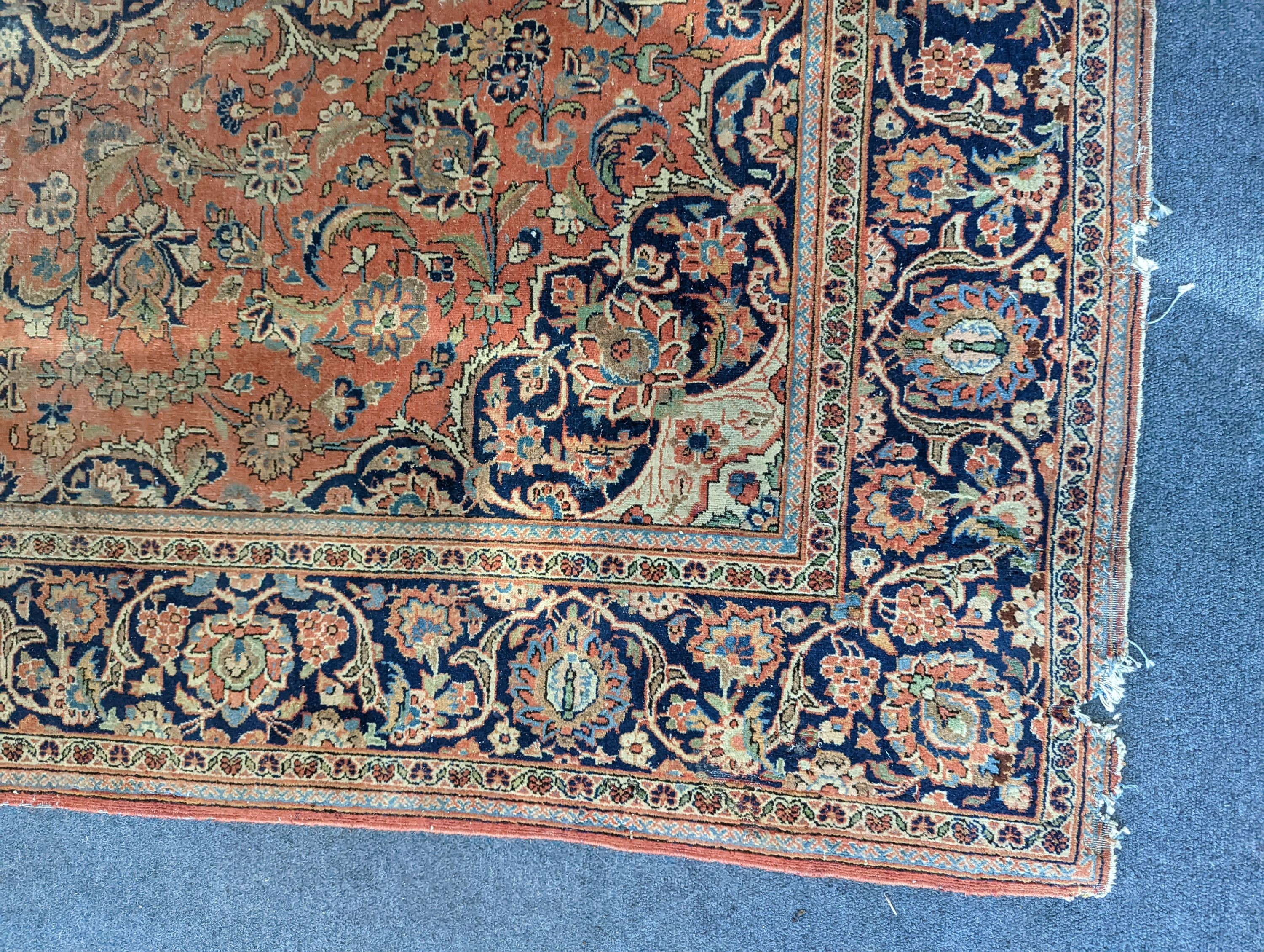 A Kashan red ground rug, 200 x 132cm